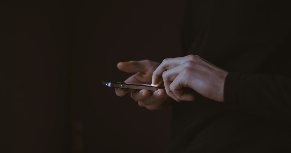 A person typing a message on a phone