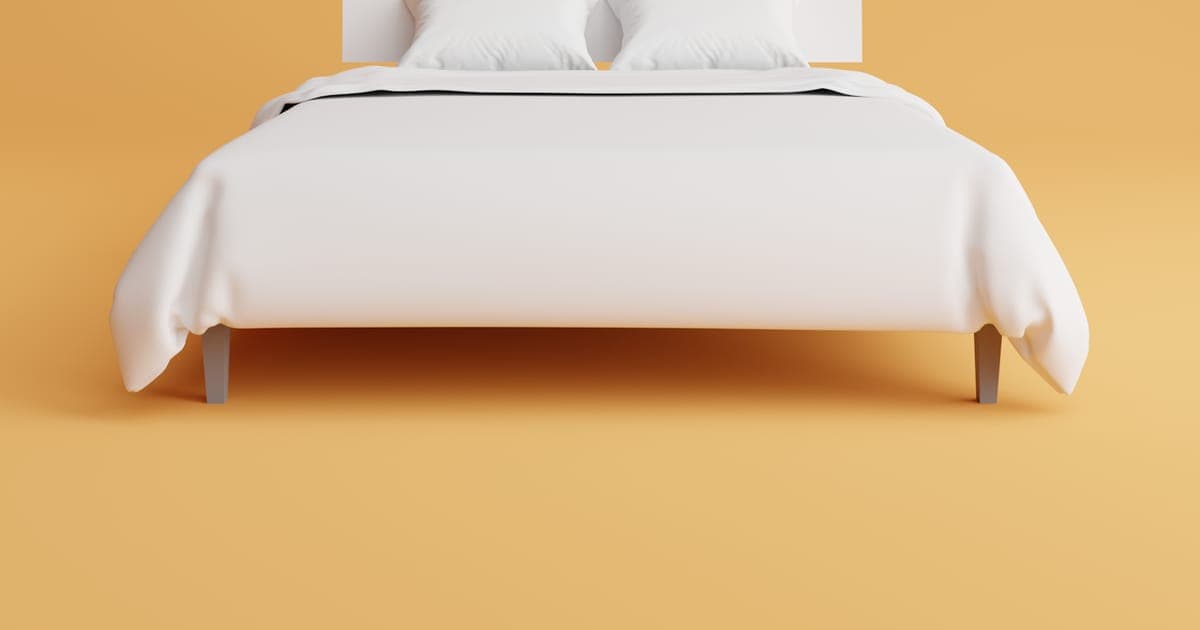 A neatly made bed in a tidy bedroom