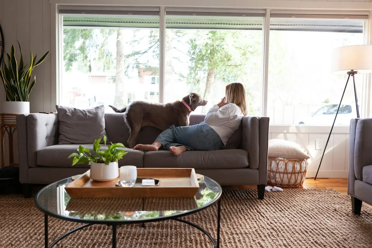 A woman relaxing at home with her dog